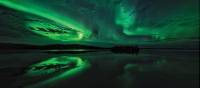 Aurora Borealis are mirrored on the lake during the summer/autumn | H Wang