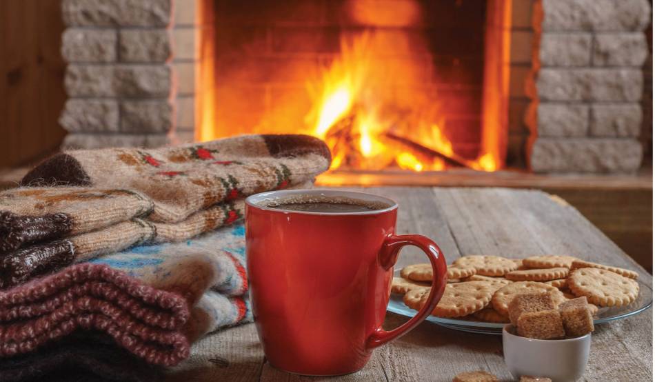 Warming up by the fire after a day spend in wintery wilderness