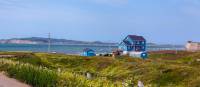 Pass by colourful houses while hiking the archipelago | André Quenneville