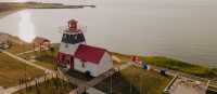 Decorated in the colours of the Acadian flag, Grande-Anse Lighthouse makes for a colourful stop