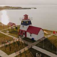 Decorated in the colours of the Acadian flag, Grande-Anse Lighthouse makes for a colourful stop