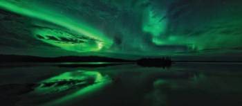 Aurora Borealis are mirrored on the lake during the summer/autumn | H Wang